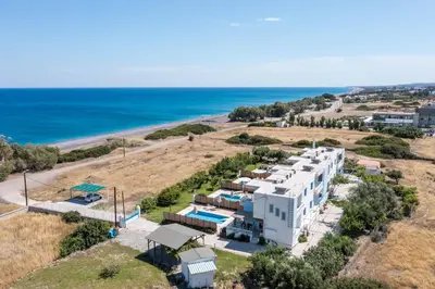 an aerial view of a hotel and the ocean at RITA MARE seafront villas heated Pools in Gennadi