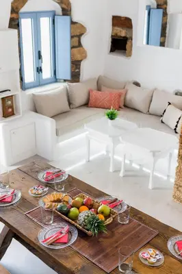 a table with a bowl of fruit on it in a living room at Casa Blue in Gennadi