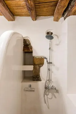 a sink in a room with a stone wall at Casa Blue in Gennadi