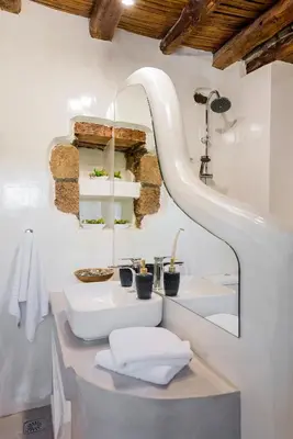 a bathroom with two sinks and a mirror at Casa Blue in Gennadi