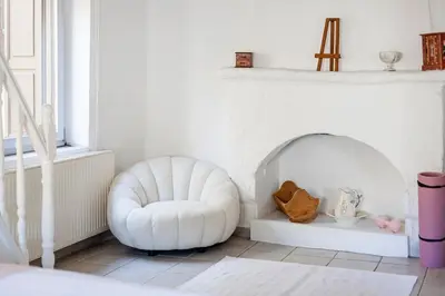 a white room with a white chair and a fireplace at Casa de La Flora by Rhodes4vacation in Rhodes Town