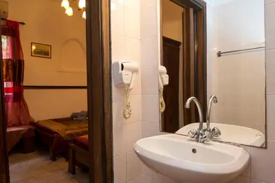 a bathroom with a sink and a phone on the wall at Spot Hotel in Rhodes Town