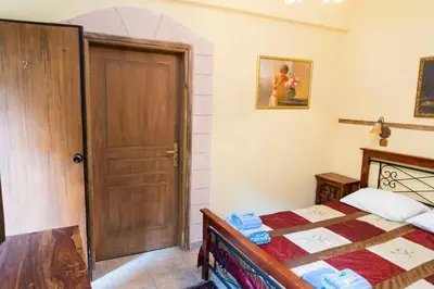 a bedroom with a bed and a wooden door at Spot Hotel in Rhodes Town