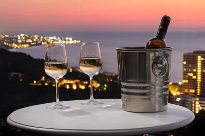 two glasses of wine on a table with a bottle of wine at Rhodes SkyLine Suites in Ixia