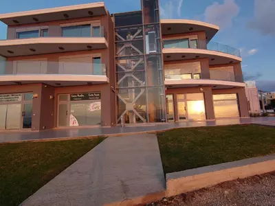 a large building with a lawn in front of it at Rhodes SkyLine Suites in Ixia