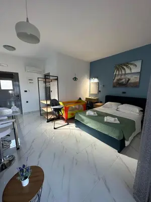 a bedroom with a bed and a table in a room at Royal Luxury Studios in Archangelos