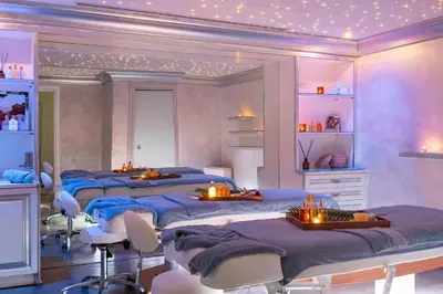 a room with four beds with candles on them at Mitsis Selection Alila in Faliraki