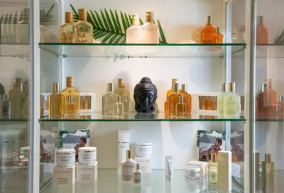 a display case filled with bottles of alcohol at Mitsis Selection Alila in Faliraki