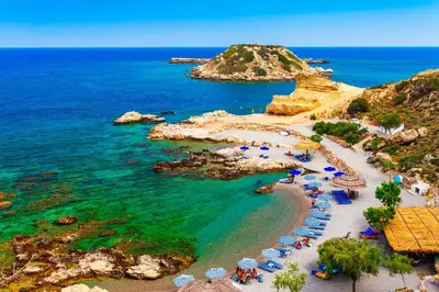 an aerial view of a beach with umbrellas and the ocean at Haraki Beach Mediterranean Retreat in Haraki