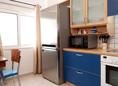 a kitchen with a refrigerator and a microwave at Haraki Beach Mediterranean Retreat in Haraki