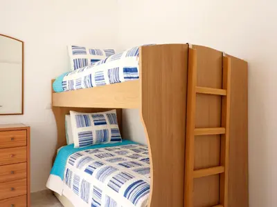 a bunk bed in a bedroom with a bunk bedutenewayewayangering at Haraki Beach Mediterranean Retreat in Haraki
