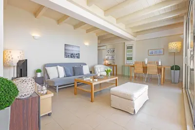 a living room with a couch and a table at Sunny Penthouse,Modern Amenities+Aegean View in Rhodes Town