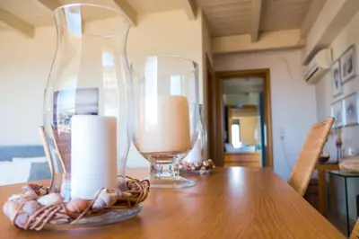 a table with two glass vases and candles on it at Sunny Penthouse,Modern Amenities+Aegean View in Rhodes Town