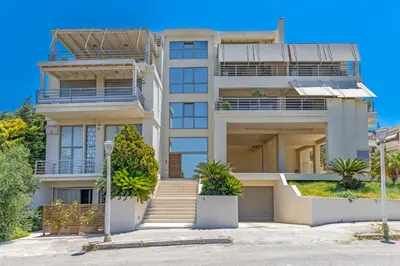 an apartment building with plants in front of it at Sunny Penthouse,Modern Amenities+Aegean View in Rhodes Town