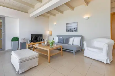 a living room with a couch and a table at Sunny Penthouse,Modern Amenities+Aegean View in Rhodes Town