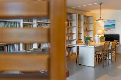 a room with a library with a table and chairs at Couple's Getaway , Modern Amenities & Sophisticated Style in Rhodes Town