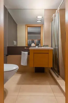 a bathroom with a sink and a toilet and a shower at Couple's Getaway , Modern Amenities & Sophisticated Style in Rhodes Town
