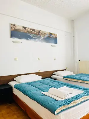 two beds sitting next to each other in a room at Prasonisi Club in Kattavía