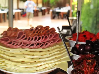 a plate of waffles and fruit on a table at Prasonisi Club in Kattavía