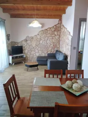 a living room with a couch and a table at Stergios summer dream house in Kolimbia