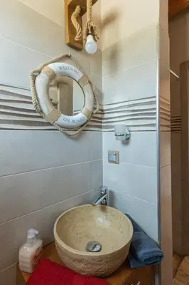 a bathroom with a sink and a mirror on the wall at Stergios summer dream house in Kolimbia