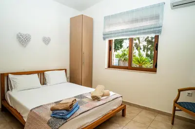 a bedroom with a bed and a window at Madia Villa in Kolimbia