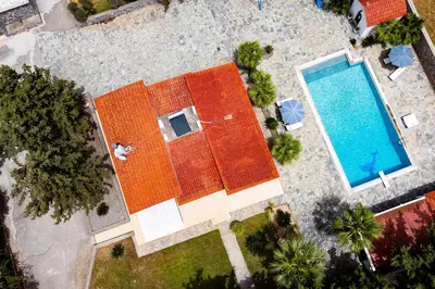 an overhead view of an orange building with a swimming pool at Madia Villa in Kolimbia