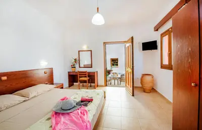 a room with a bed and a table with a hat on it at KRANA Hotel in Líndos
