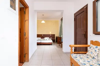 a corridor of a hotel room with a bedroom at KRANA Hotel in Líndos