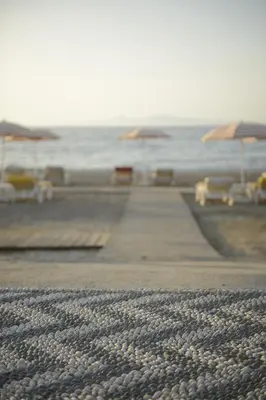 a boardwalk leading to the ocean with umbrellas at ABAV2 Suites by Rodos Palace in Ixia