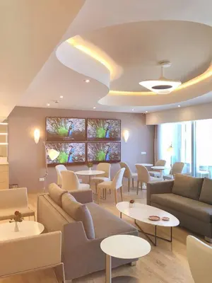 a living room with a couch and chairs and tables at ABAV2 Suites by Rodos Palace in Ixia