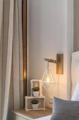 a bedroom with a bed and a lamp on a table at Kokona in Symi
