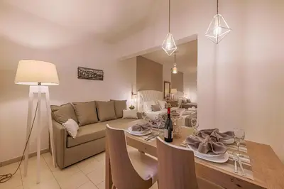 a living room with a couch and a dining room table at Kokona in Symi
