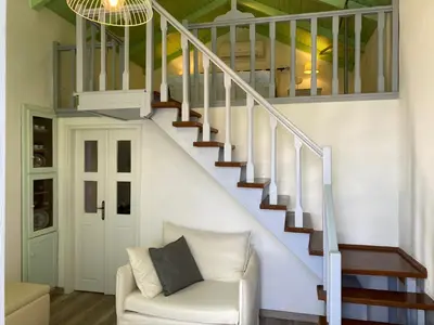 a living room with a staircase and a couch at Thodoris Infinity View Apartments in Symi
