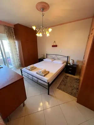 a bedroom with a bed and a chandelier at Apartment 29 in Rhodes Town