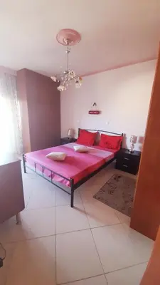 a bedroom with a large pink bed in a room at Apartment 29 in Rhodes Town