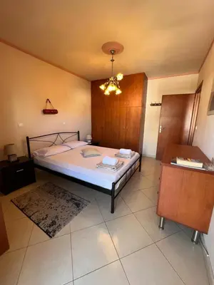 a bedroom with a bed and a chandelier at Apartment 29 in Rhodes Town