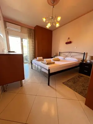 a bedroom with a bed and a chandelier at Apartment 29 in Rhodes Town