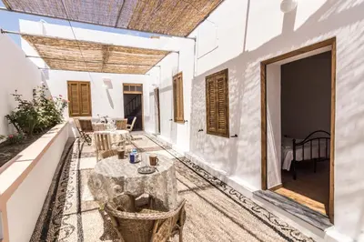 an outdoor patio with a table and chairs at Villa Mika in Líndos