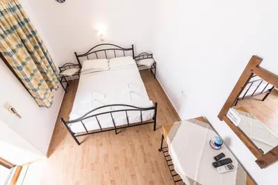 an overhead view of a bedroom with two beds and a table at Villa Mika in Líndos