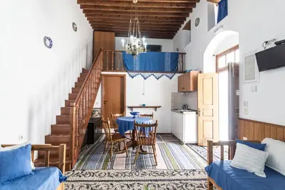 a living room with a table and a dining room at Villa Mika in Líndos