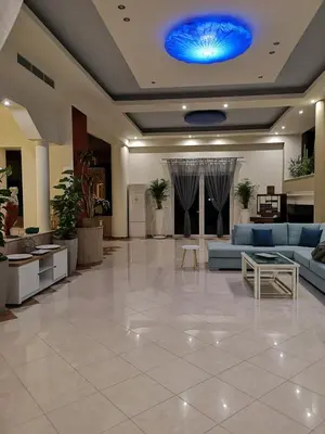 a lobby with couches and a blue ceiling at Louis Luxury Villa by living in blue in Rhodes Town