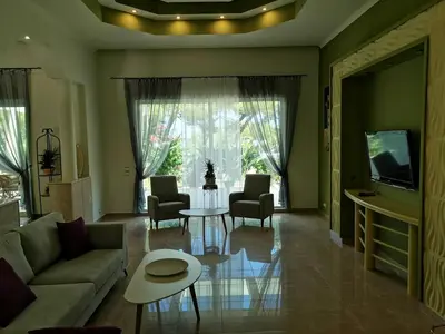 a living room with a couch and chairs and a table at Louis Luxury Villa by living in blue in Rhodes Town