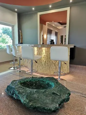 a bar in a room with a table and chairs at Louis Luxury Villa by living in blue in Rhodes Town