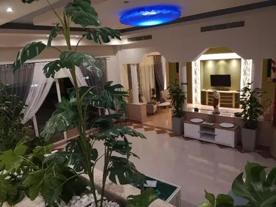 a lobby with plants and a blue ceiling at Louis Luxury Villa by living in blue in Rhodes Town