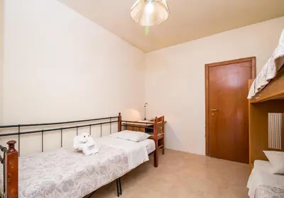 a bedroom with two twin beds and a closet at Cozy Family Home steps from the Beach in Afantou