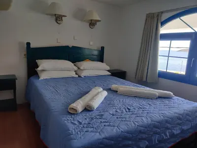 a bed with two towels on top of it at Blue Sky Aparts in Livadia