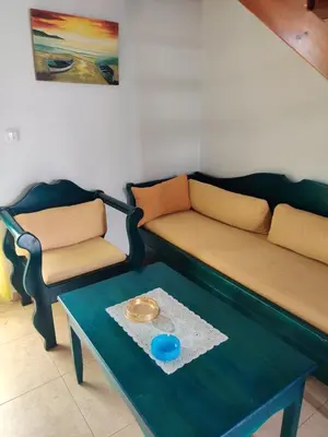 a living room with a couch and a table at Blue Sky Aparts in Livadia
