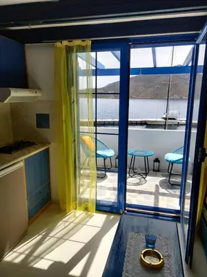 a kitchen with a large window and a balcony at Blue Sky Aparts in Livadia