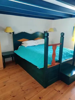 a bedroom with a bed with a blue headboard at Blue Sky Aparts in Livadia
